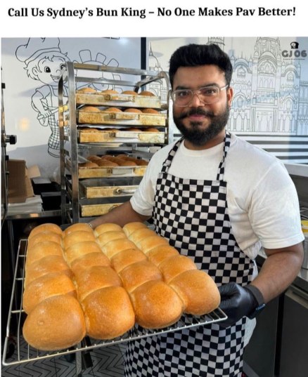 Siddharth Darji holding a fresh tray of golden Ladi Pav buns